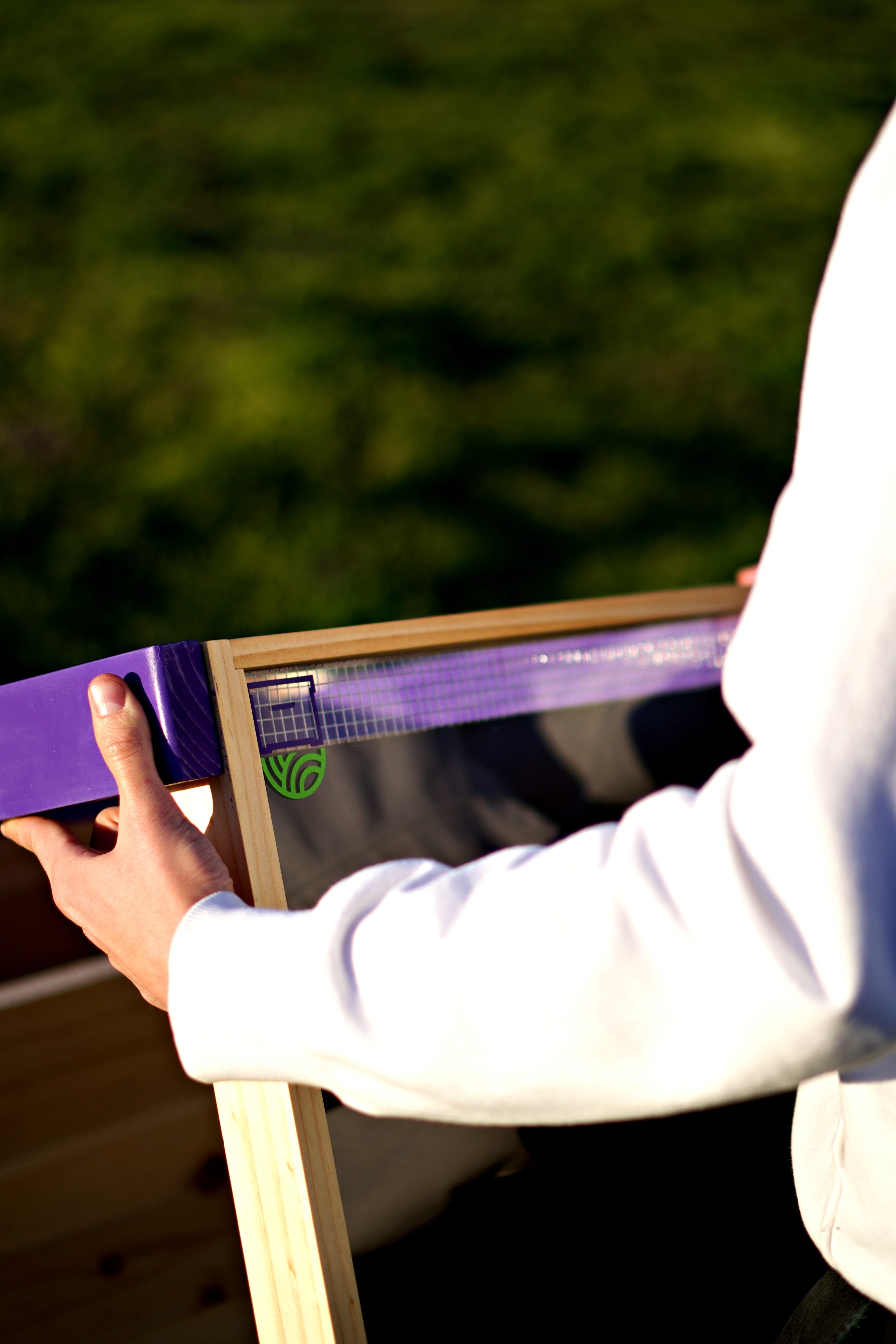 A man holds a HiveHeater to examine it.